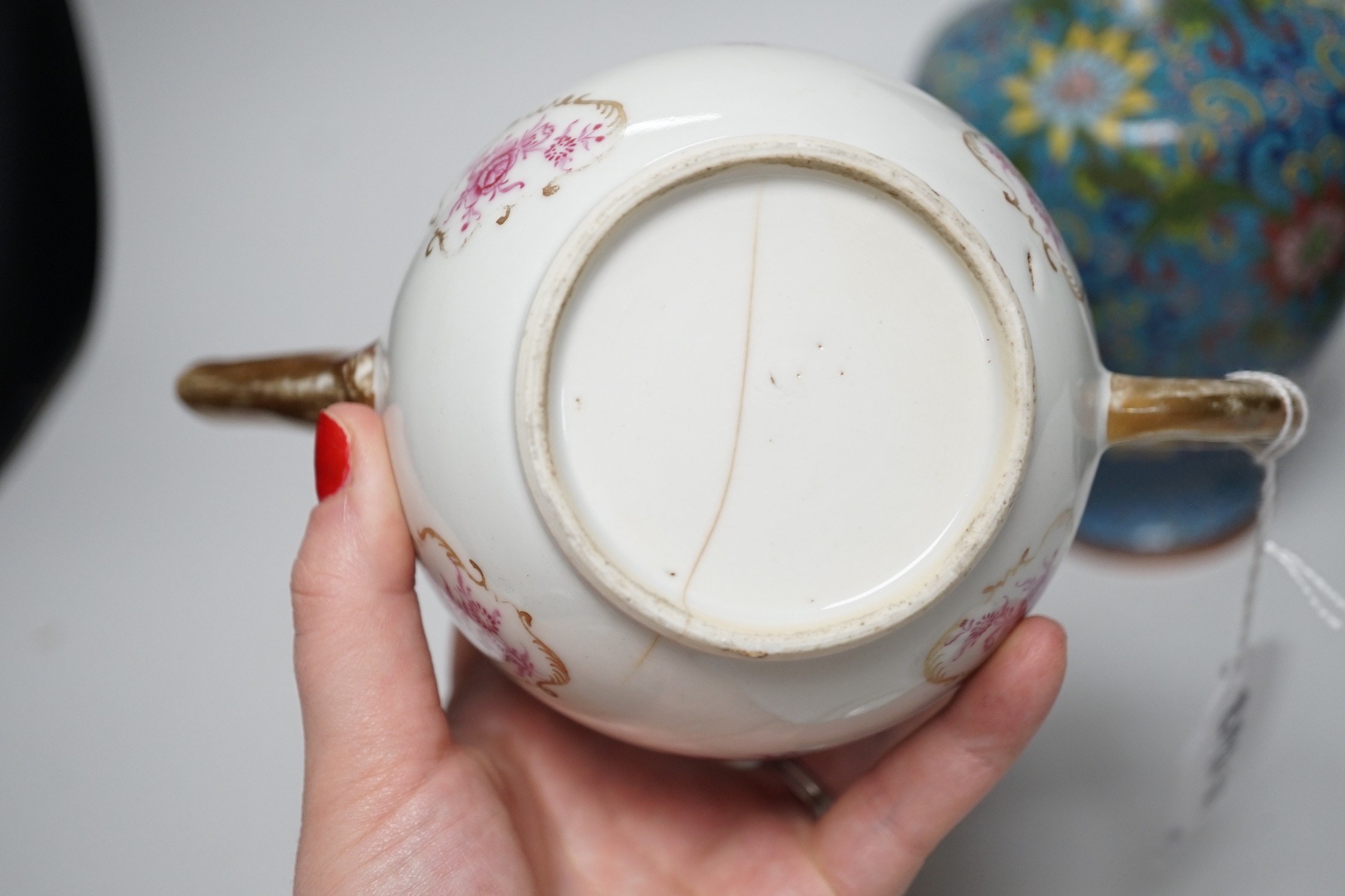 A selection of Oriental ceramics, to include a Chinese pink enamelled export teapot and matching tea bowls, a cloisonné blue ground vase, and a blue Japanese crackle glaze, (5). Tallest 23cm